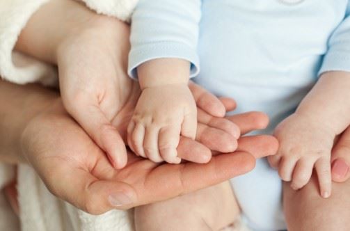 A Baby Holding It's Parents Hand 